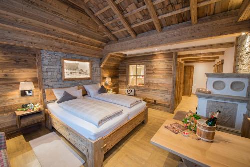 a bedroom with a bed in a room with wooden walls at Wellness-Hotel ADLER in Bad Wörishofen