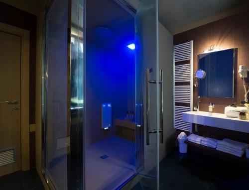a bathroom with a glass shower and a sink at Hotel Guglielmo in Catanzaro