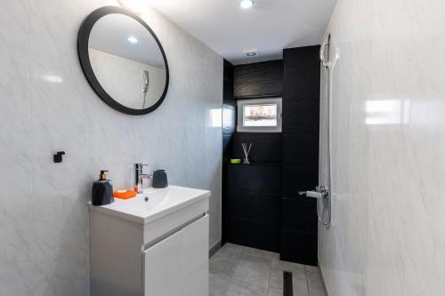 a bathroom with a white sink and a mirror at Bobevata guest house - Floor 2 - Stunning view Old town in Veliko Tŭrnovo