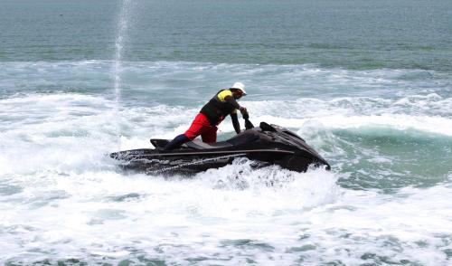 a man on a jet ski in the water at Lagoona Beach Luxury Resort and Spa in Manama
