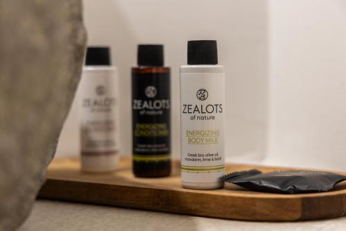 three bottles of hair products on a wooden tray at Pergola in Pollonia