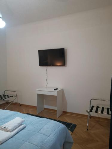 a bedroom with a bed and a tv on the wall at Eisenerzer Apartments - Radmeisterhaus in Eisenerz