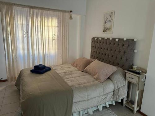a bedroom with a bed with a blue towel on it at LO DE LOLO Monte Grande A minutos del aeropuerto in Monte Grande