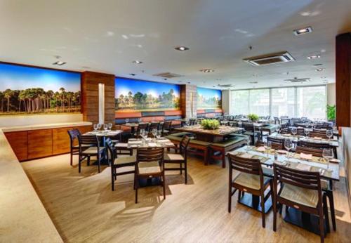 a restaurant with tables and chairs in a room at Hotel Estelar Yopal in Yopal