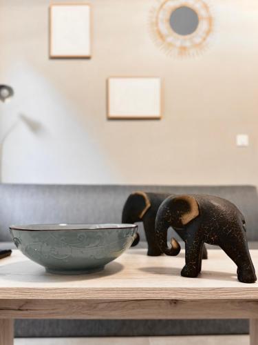 a bowl and an elephant statue on a table at FiloXenia by the Sea in Agios Nikolaos