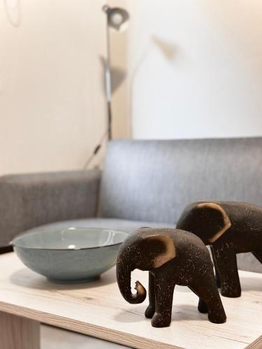 two elephants on a table next to a bowl at FiloXenia by the Sea in Agios Nikolaos