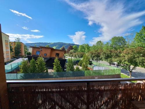 a view of a garden from the balcony of a house at Przy Szlaku Zakopane centrum pokoje & apartamenty in Zakopane