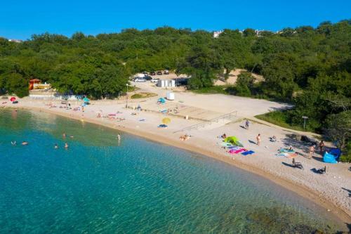 an aerial view of a beach with people on it at Krk Njivice in Njivice