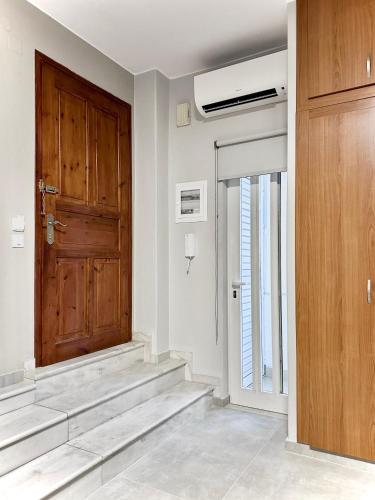 a room with a wooden door and stairs at FiloXenia by the Sea in Agios Nikolaos