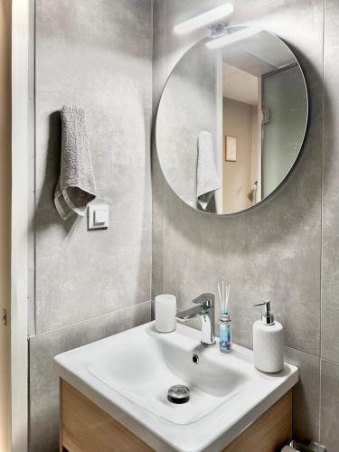 a bathroom with a sink and a mirror at FiloXenia by the Sea in Agios Nikolaos