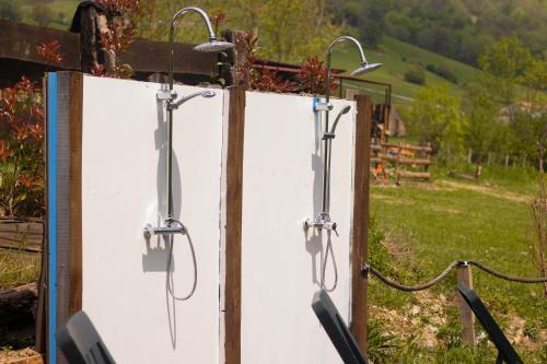 a pair of pivot doors in a field at Hostal Rural Iratiko Urkixokoa in Orbaiceta