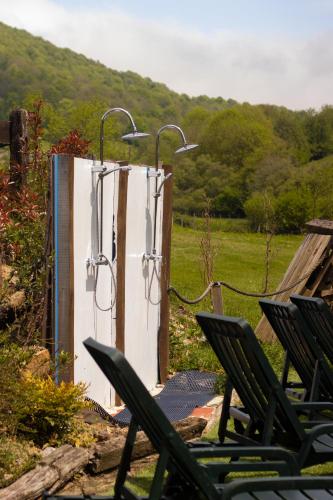a refrigerator with two lights on it next to chairs at Hostal Rural Iratiko Urkixokoa in Orbaiceta
