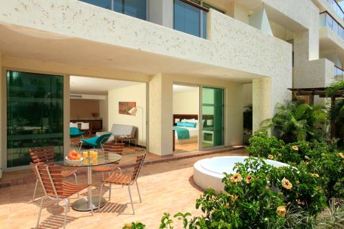 a house with a patio with a table and chairs at Estelar Playa Manzanillo - All inclusive in Cartagena de Indias