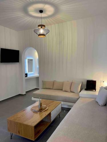 a living room with a couch and a coffee table at Sklavadi Vineyard House in Kamari