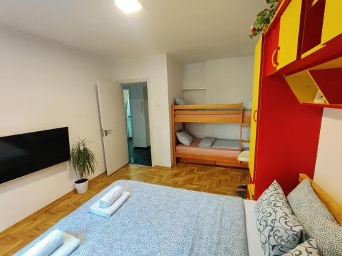 a small room with a bed and a bunk bed at Ana Apartment in Novi Sad