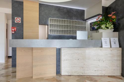 a reception desk in a lobby with wood at Hotel Continental in Caorle