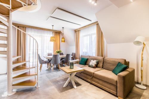 a living room with a couch and a table at Apartamenty Krokusowa Dolina in Kościelisko
