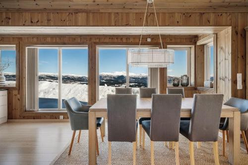 a dining room with a table and chairs with a view at Voss Resort self-service apartments in Skulestadmo