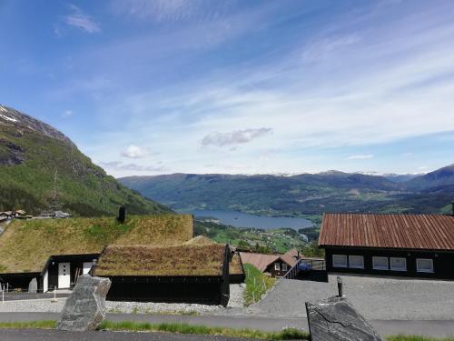 a view of a valley with a building with grass at Voss Resort self-service apartments in Skulestadmo