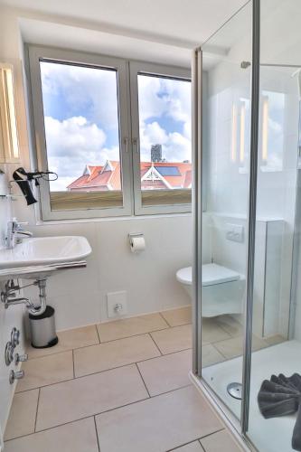 a bathroom with a shower and a toilet and a sink at An´t Kark in Langeoog
