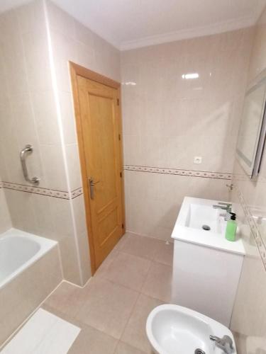 a bathroom with a toilet and a tub and a sink at Bol01 - Modern 2 bedroom apartment in Bolnuevo in Bolnuevo