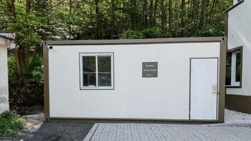a white garage with two doors and a window at Apartment Ski and Relax in Horní Žďár