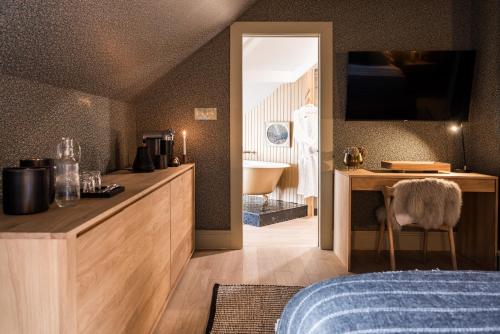 a bedroom with a bed and a television on the wall at Dvele Inn in St. John's