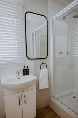 a bathroom with a sink and a shower at Lavender BnB in East London