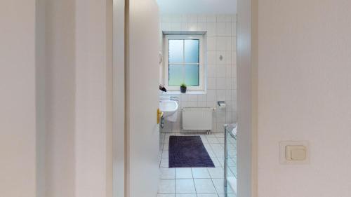 bagno con servizi igienici, lavandino e specchio di Nautic W06 a Laboe