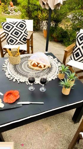 a table with glasses of wine and a pie on it at Casa Domenica in Zakynthos Town