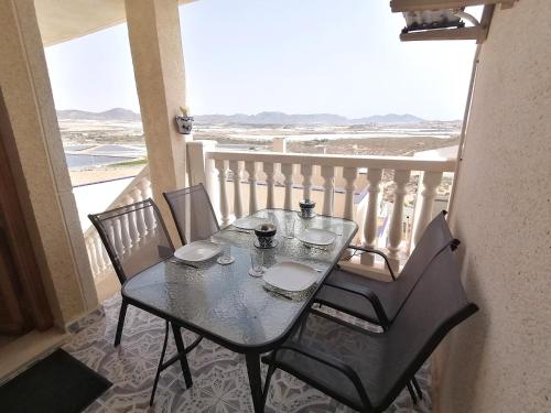 a table and chairs on a balcony with a view of the ocean at Bol01 - Modern 2 bedroom apartment in Bolnuevo in Bolnuevo