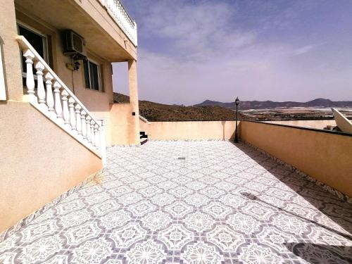 a balcony with a tiled floor on a building at Bol01 - Modern 2 bedroom apartment in Bolnuevo in Bolnuevo