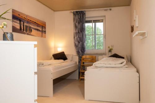 a room with two beds and a window at Baltic Appartement in Laboe