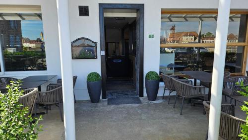 a restaurant with tables and chairs in a building at Auberge de la Marine in Losne
