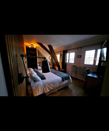 a bedroom with a bed with surfboards on it at Auberge de la Marine in Losne