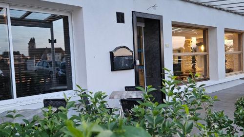 a building with a window with a bench in front of it at Auberge de la Marine in Losne