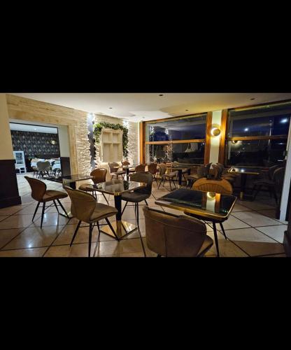 a dining room with tables and chairs in a room at Auberge de la Marine in Losne