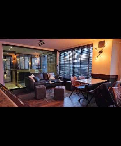 a living room with a couch and a table at Auberge de la Marine in Losne