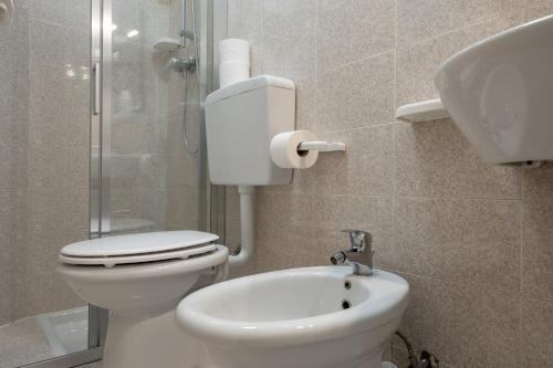 a bathroom with a toilet and a sink at Hotel Continental in Caorle
