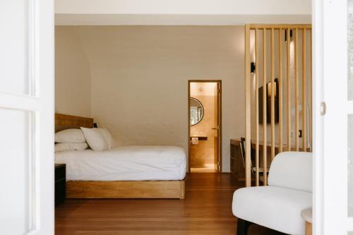 a bedroom with two beds and a mirror at La Posada del Puente in Arequipa