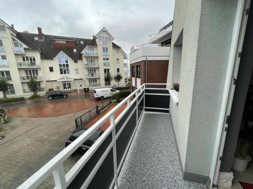 a balcony with a view of a street and buildings at Fewo Kuhnert in Laboe