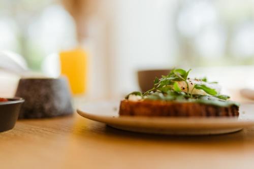 a plate of food on a wooden table at La Posada del Puente in Arequipa