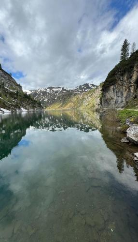a large body of water with mountains in the background at Zimmer & Appartements Schwarzenbacher Sonja & Konrad in Kleinarl