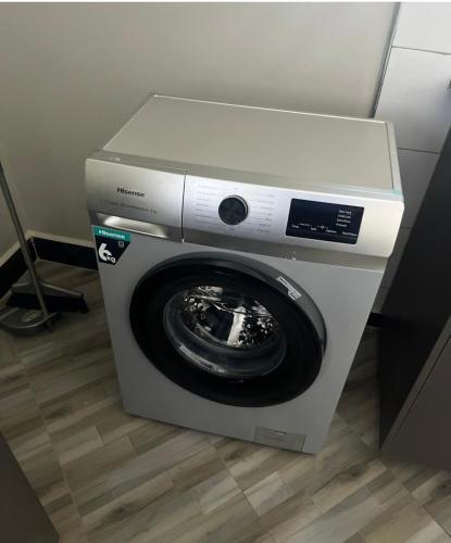 a washing machine with its door open in a room at Muntaha homes in Kampala