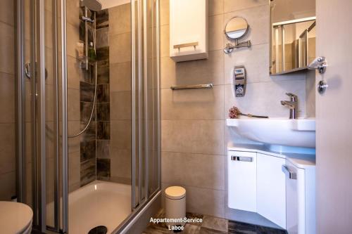 a bathroom with a shower and a toilet and a sink at EdelStein in Stein