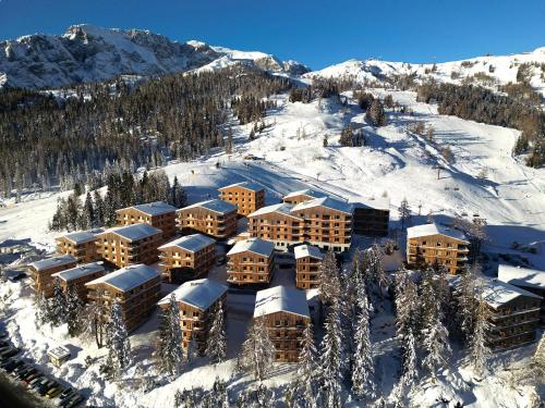 an aerial view of a resort in the snow at Nassfeld - SkiIn-SkiOut direkt an der Piste mit Sauna - Bergzauber9 in Hermagor