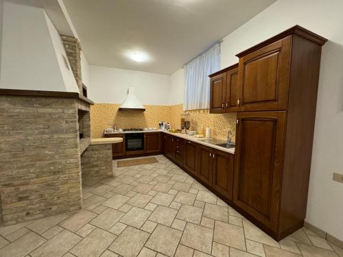 a large kitchen with wooden cabinets and a tile floor at Villa Emilia in Fossacesia