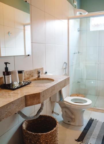 a bathroom with a sink and a toilet at Hotel Pousada Rancho das Dunas in Santo Amaro