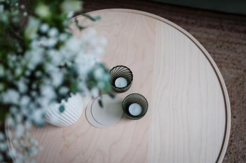 a wooden table with two knobs on it with flowers at Bismarck 1884 B6 in Norderney