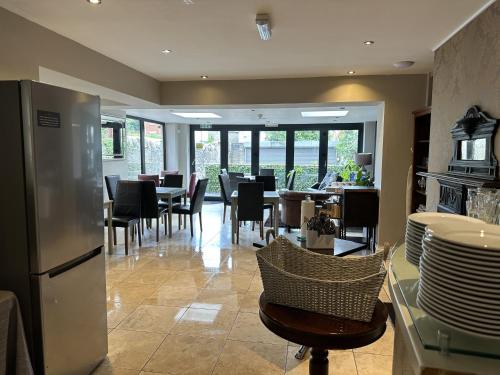 a kitchen and dining room with tables and chairs at Number One Hundred Bed And Breakfast in Cardiff
